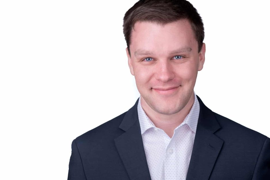young man headshot on white background in a jacket without tie