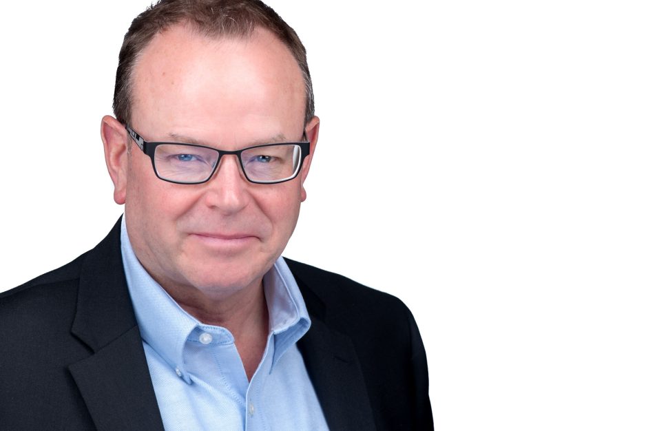 Business man headshot in ottawa in a blue blazar and blue shirt on a white background