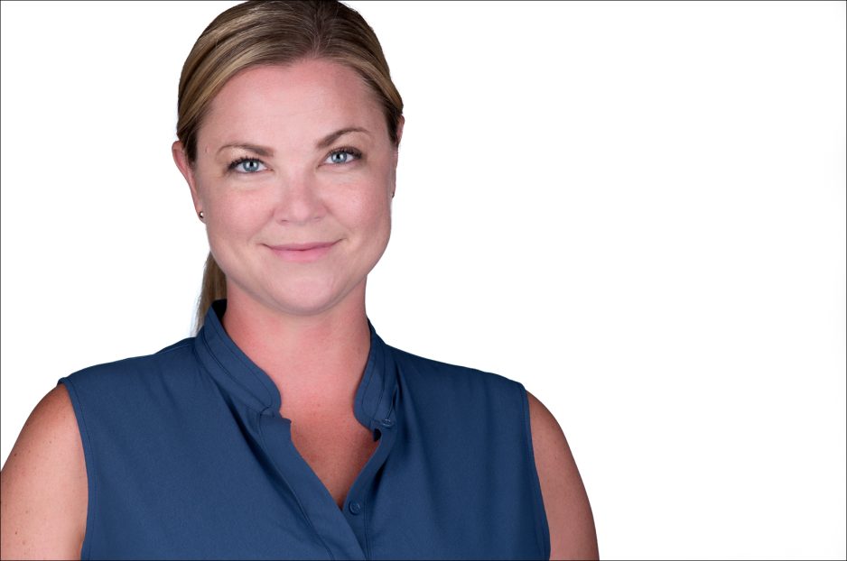 Pretty woman in blue top on white background headshot