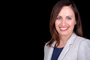 Doctor headshot on a black background female doctor pretty smile