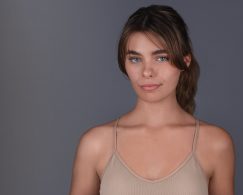 Young woman with her hair tied back and a pouty, sultry look