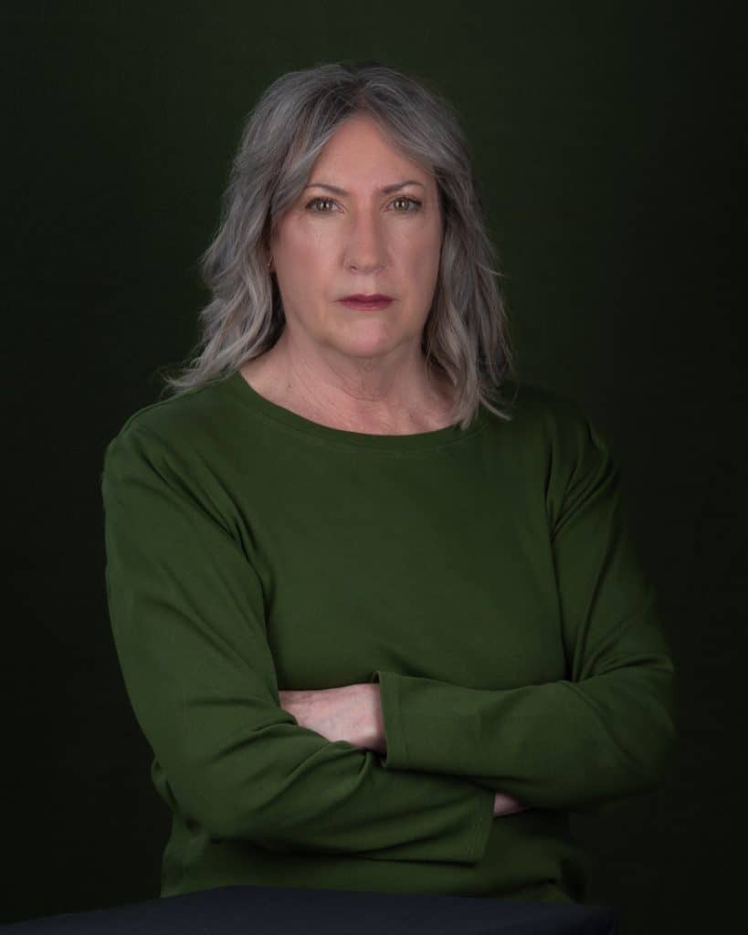 Straight faced Ottawa business headshot green top grey hair
