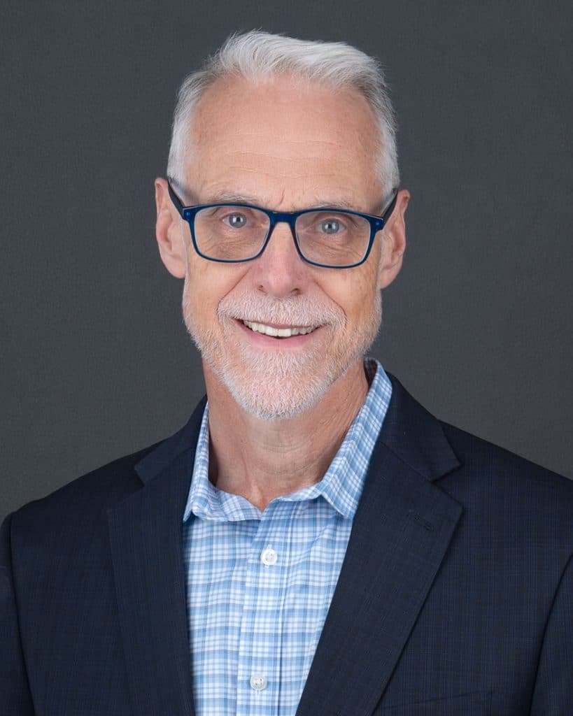 Older businessman Ottawa headshot with blue suit, checkered shirt, blue glasses and beard
