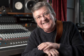 Les Emmerson headshot sitting at audio control board ottawa